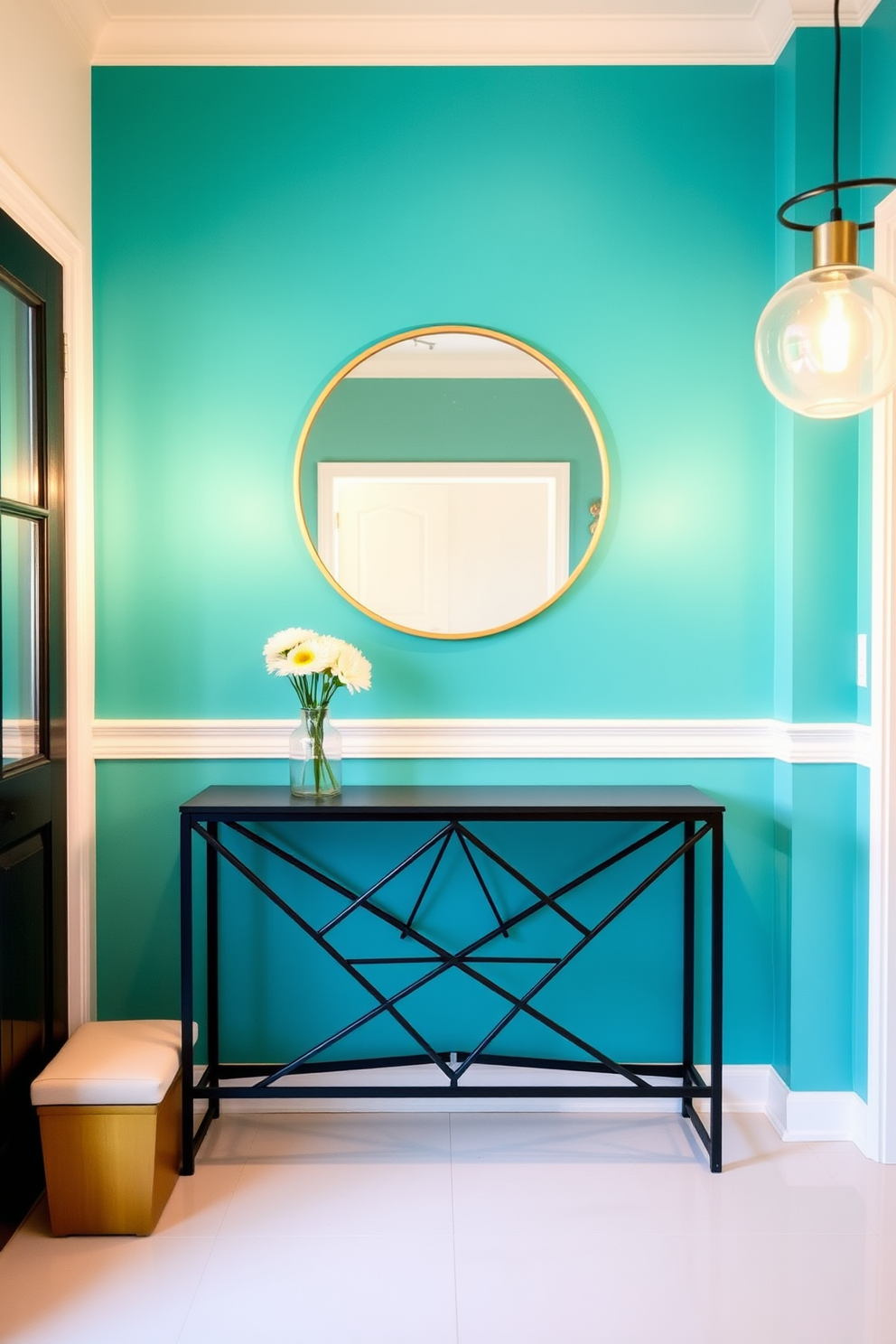 A vibrant accent wall painted in a bold teal color serves as the focal point of the foyer. The floor features sleek white tiles, and a stylish console table with a geometric design is placed against the wall. A large round mirror with a thin gold frame hangs above the console table. Flanking the table are two modern pendant lights that cast a warm glow, enhancing the inviting atmosphere of the space.