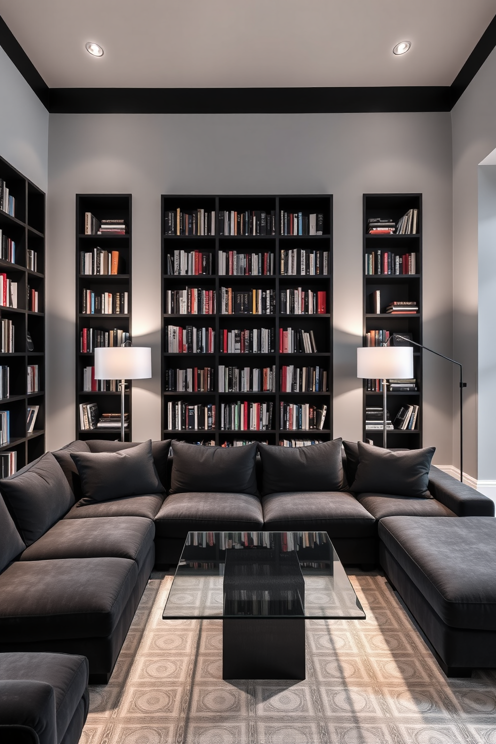 A modern home library featuring a monochromatic color scheme that exudes elegance. The walls are painted in a soft gray, complemented by sleek black bookshelves filled with an array of books. A large, comfortable sectional sofa in a dark charcoal fabric invites relaxation, while a minimalist glass coffee table sits in front. Ambient lighting from stylish floor lamps creates a warm atmosphere, enhancing the sophisticated feel of the space.