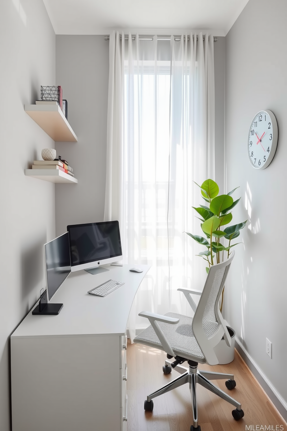 A modern home office designed for small spaces features a sleek white desk positioned against a light gray wall. A comfortable ergonomic chair complements the desk, and above it, floating shelves display books and decorative items. Natural light floods the room through a large window adorned with sheer curtains, creating an airy atmosphere. A potted plant in the corner adds a touch of greenery, while a minimalist wall clock keeps the space functional and stylish.