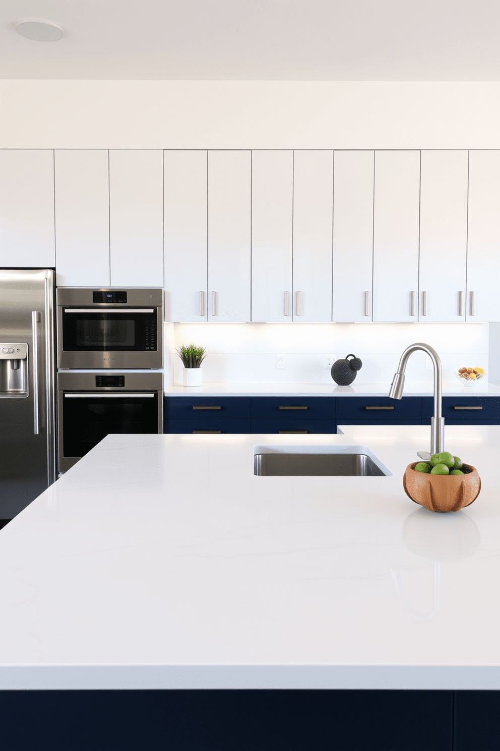 A modern kitchen featuring sleek quartz countertops that provide both durability and elegance. The cabinetry is a mix of matte white and deep navy blue, with stainless steel appliances seamlessly integrated into the design.