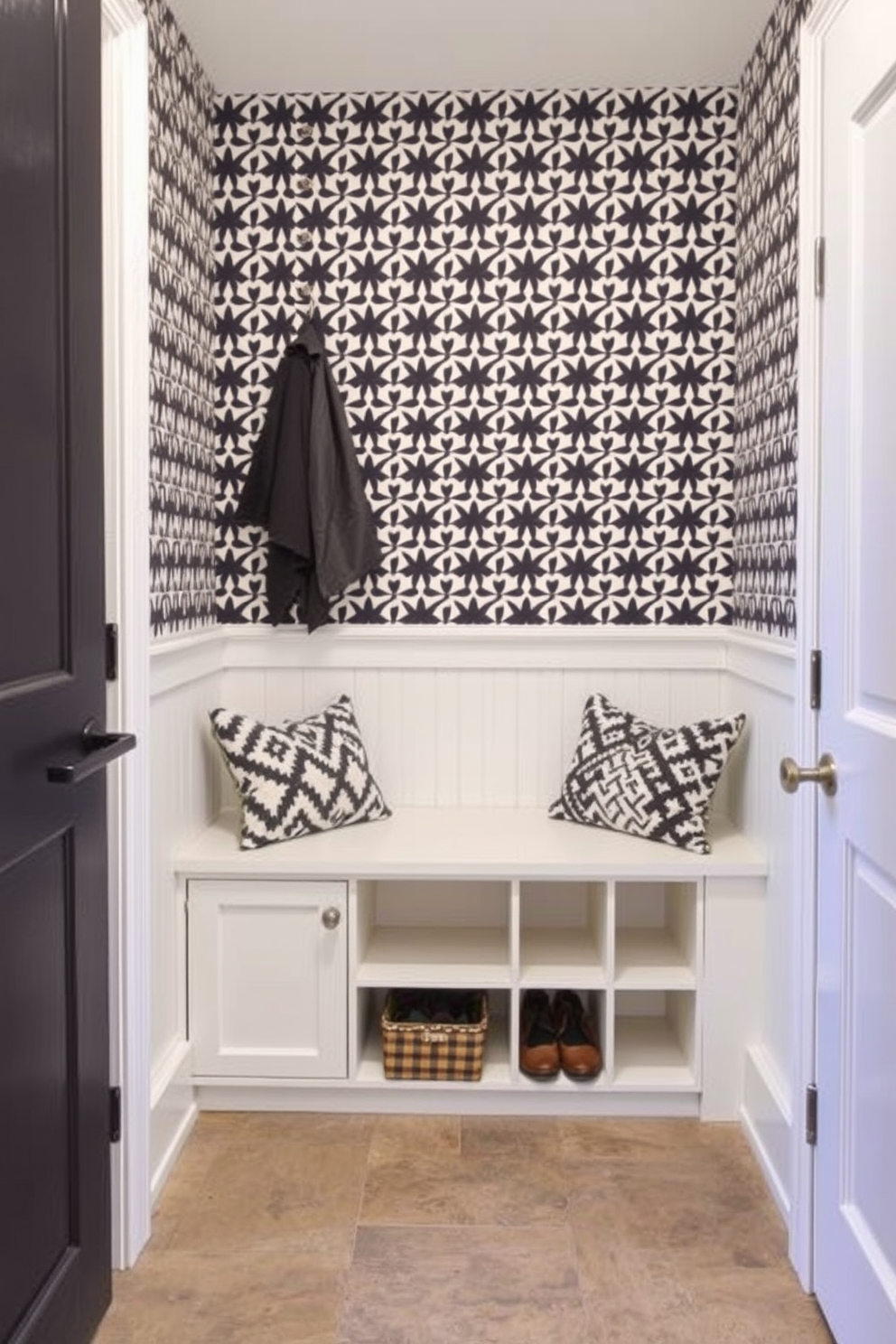 A stylish mudroom features wallpaper with a bold geometric pattern that adds a unique touch to the space. The flooring is a durable tile that complements the wallpaper, while a built-in bench with storage cubbies provides both functionality and style.