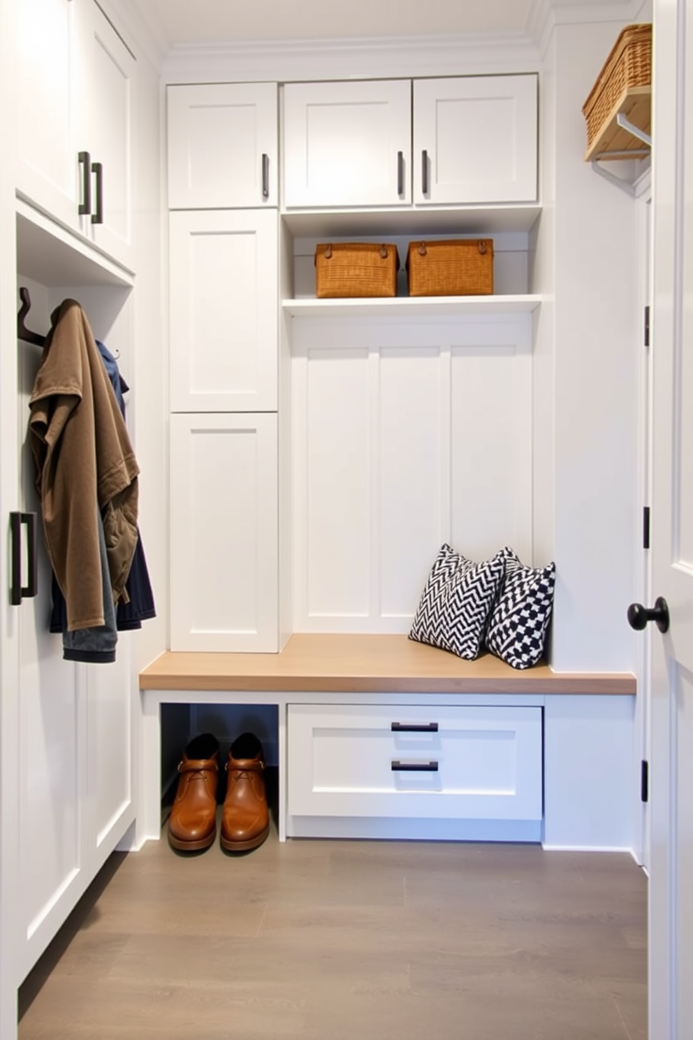 A modern mudroom features easy-to-clean surfaces that prioritize practicality and style. The space includes a built-in bench with storage underneath, surrounded by sleek cabinetry and durable flooring that withstands heavy foot traffic.