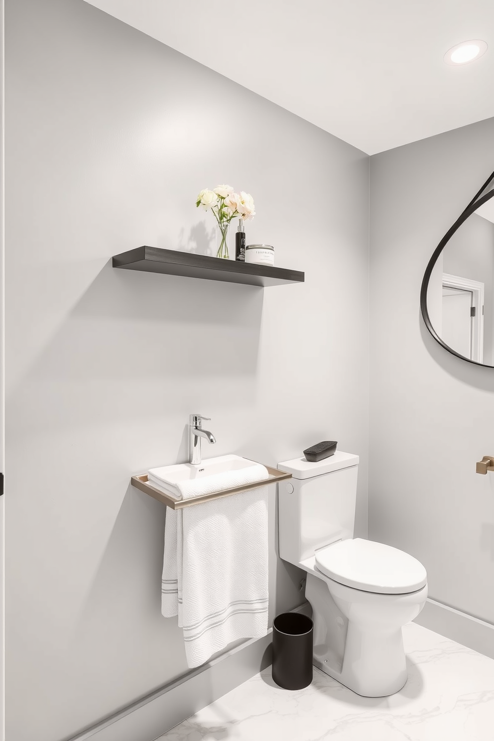 A modern powder room features sleek, minimalist towel racks made of brushed nickel, enhancing the contemporary aesthetic. The walls are adorned with a soft gray paint, while the floor showcases elegant white marble tiles, creating a sophisticated ambiance. Incorporate floating shelves above the towel racks for additional storage and display of decorative items. A round mirror with a black frame complements the overall design, adding a touch of elegance to the space.