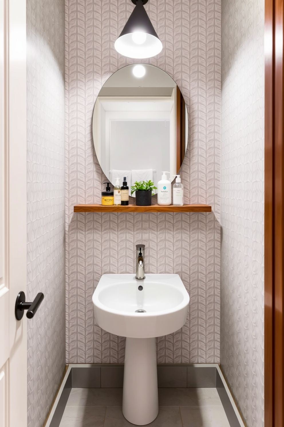 A compact corner sink with a sleek, stylish faucet is the focal point of this modern powder room. The walls are adorned with a chic geometric wallpaper, and the floor features a light gray tile that complements the overall aesthetic. A minimalist wooden shelf above the sink holds neatly arranged toiletries and a small potted plant for a touch of greenery. Soft, ambient lighting from a contemporary fixture casts a warm glow, enhancing the inviting atmosphere of the space.