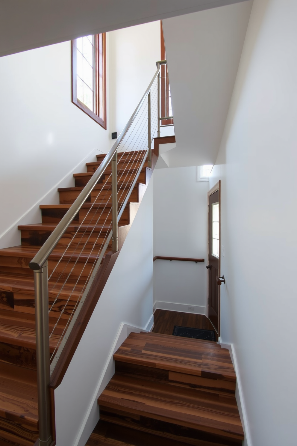 A stunning staircase featuring reclaimed wood steps that add warmth and character to the space. The handrail is crafted from sleek metal, providing a contemporary contrast to the rustic wood. Natural light floods the area through a large window, highlighting the unique grain of the wood. The walls are painted in a soft white, allowing the staircase to be the focal point of the entryway.