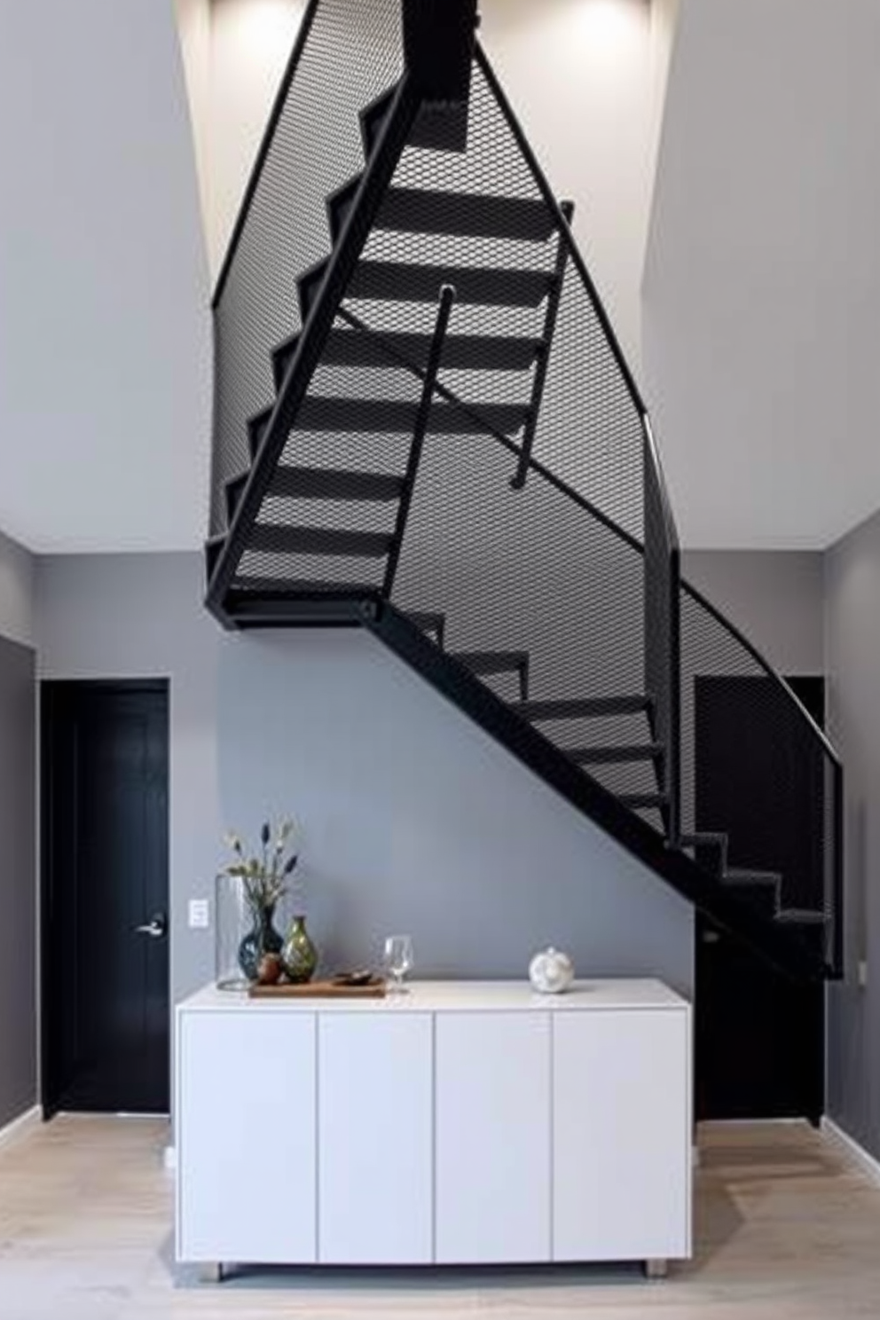 A striking metal mesh staircase features sleek lines and an open design that adds an edgy touch to any space. The staircase is illuminated by recessed lighting, highlighting the texture of the mesh and creating a dramatic focal point in the room. The surrounding walls are painted in a soft gray, providing a contemporary backdrop that complements the industrial feel of the staircase. Below, a minimalist console table showcases decorative items, enhancing the modern aesthetic of the entryway.