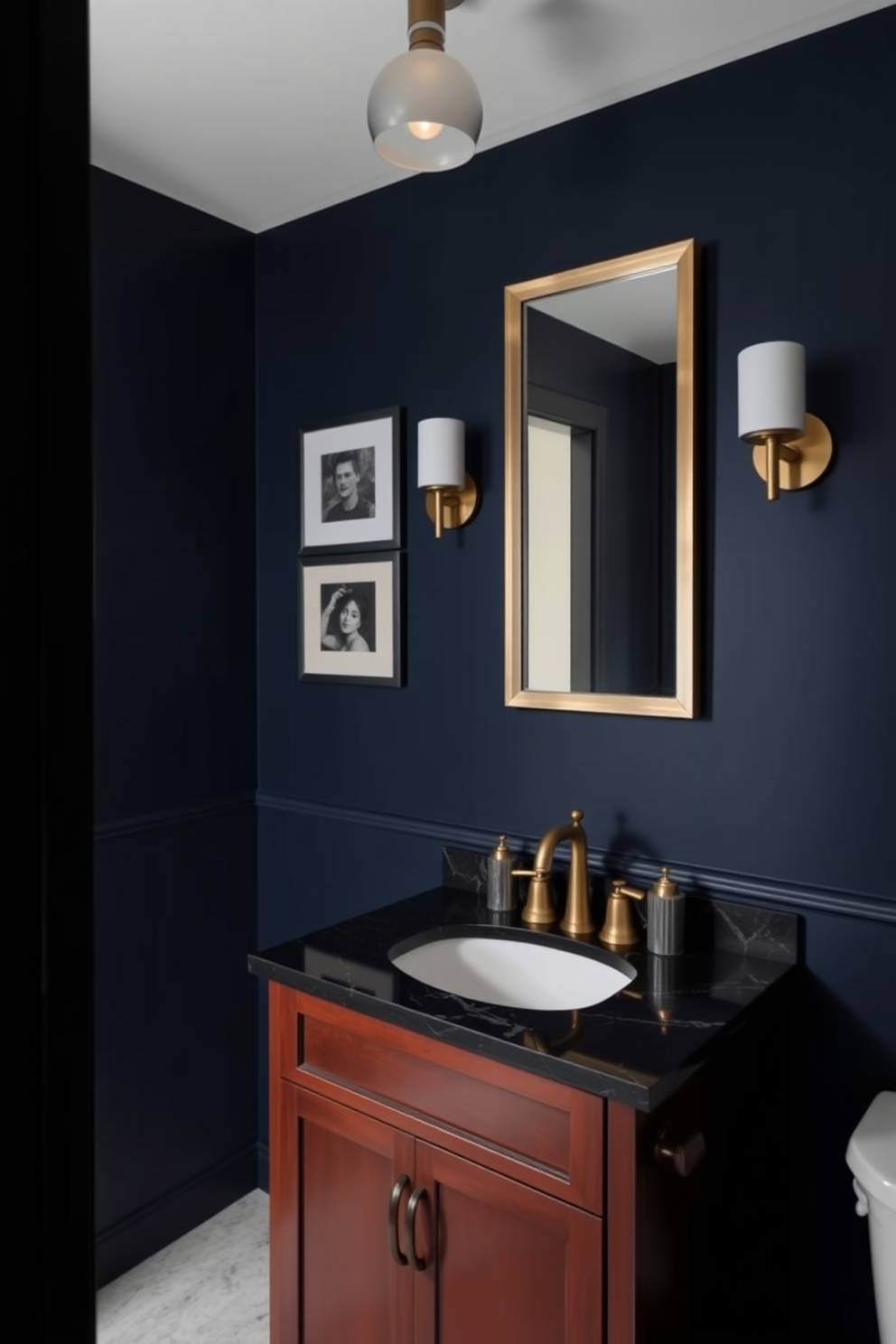 A moody powder room features dark walls painted in rich navy blue, creating an intimate atmosphere. Subtle metallic accents, such as a brushed gold faucet and a sleek silver mirror frame, add a touch of glamour to the space. The vanity is a deep mahogany with a black marble top, contrasting beautifully with the dark walls. Soft lighting from a stylish pendant fixture enhances the room's ambiance, casting a warm glow over the elegant decor.