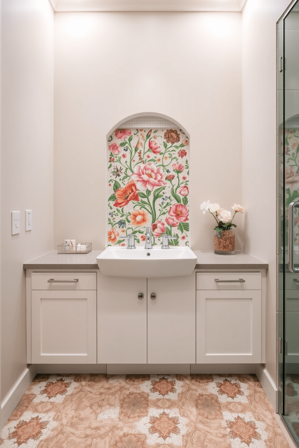 A stunning bathroom design featuring an intricate floral mosaic sink backsplash that adds a touch of elegance. The mosaic tiles are arranged in a vibrant pattern, creating a focal point behind a modern sink with sleek fixtures. The surrounding walls are painted in a soft neutral tone to enhance the beauty of the mosaic. Complementing the design, the bathroom floor is adorned with subtle, textural tiles that provide a harmonious balance to the overall aesthetic.