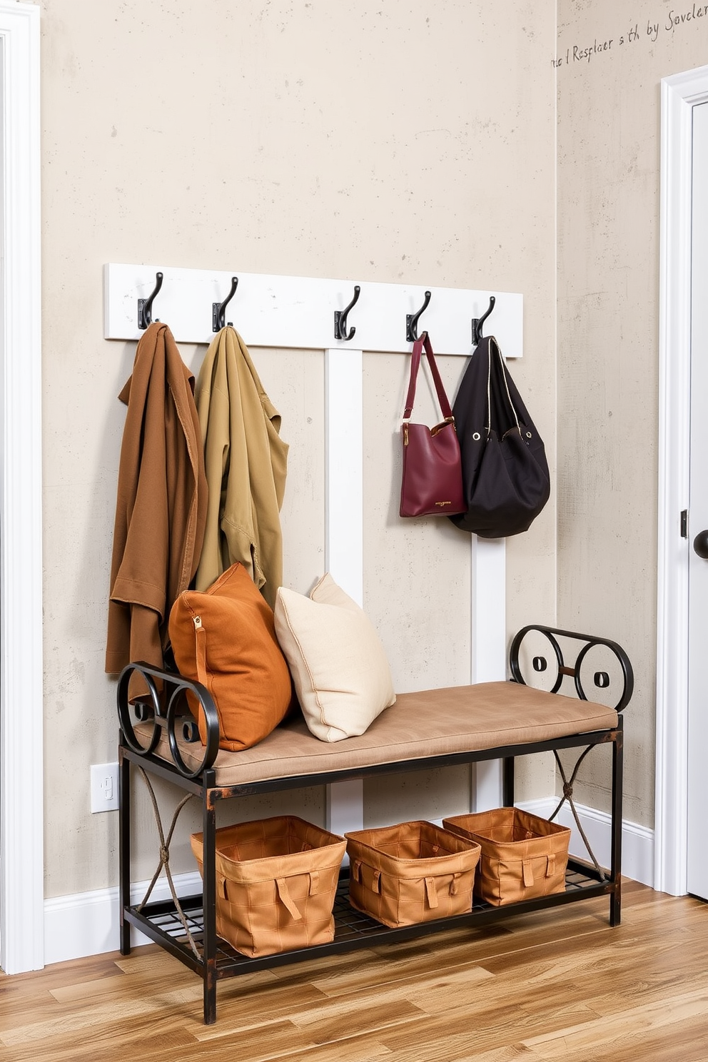 A mudroom featuring a bench with a rustic metal frame sits against a textured wall. The bench is adorned with soft cushions in earth tones and is complemented by hooks above for hanging jackets and bags.