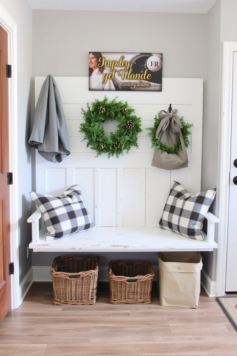 A cozy farmhouse style bench with a shiplap backrest is nestled against the wall of a mudroom. The bench features a distressed white finish and is adorned with soft cushions in muted plaid patterns.