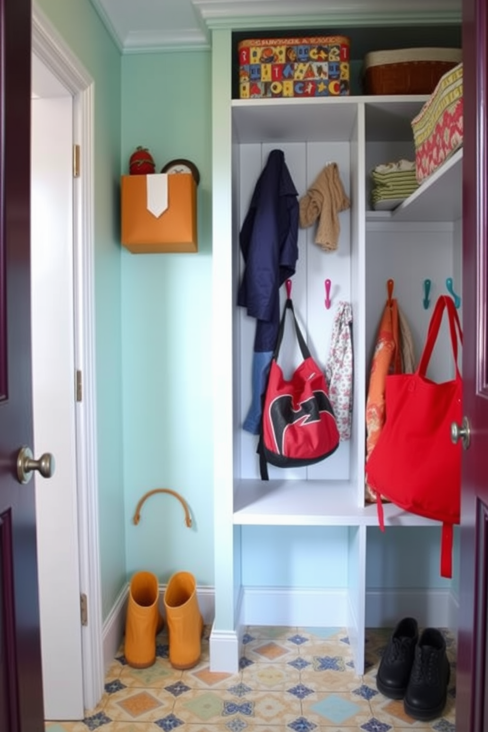 A vibrant mudroom closet designed for kids features colorful hooks at varying heights for easy access to jackets and bags. The walls are painted in a cheerful pastel hue, and the floor is adorned with playful patterned tiles to create a fun and inviting atmosphere.