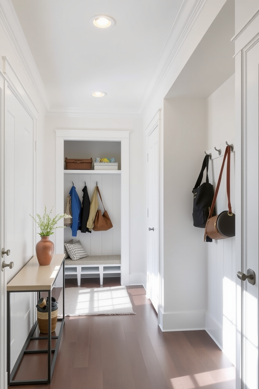 A bright and inviting entryway featuring recessed lighting that highlights the architectural details of the space. The walls are painted in a soft white, and a sleek console table sits against one side, adorned with decorative objects. A functional mudroom closet designed with built-in shelving and hooks for coats and bags. The space includes a bench with storage underneath, and the flooring is durable yet stylish, perfect for high traffic areas.