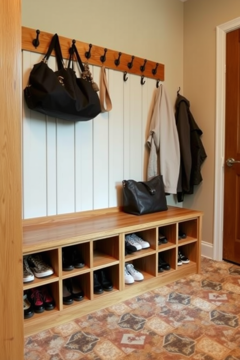 A functional mudroom featuring under-bench shoe cubbies for optimal organization. The cubbies are made of natural wood, providing a warm and inviting atmosphere. Above the cubbies, a row of hooks is mounted on the wall for hanging coats and bags. The floor is covered with durable, patterned tiles that are easy to clean and add visual interest.