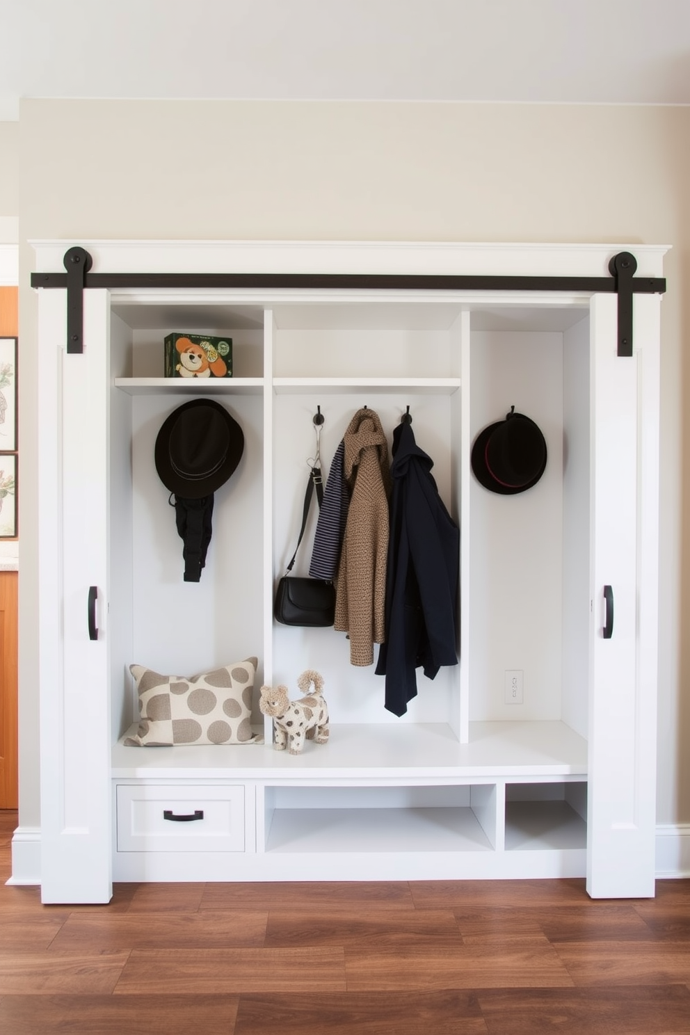 A functional mudroom featuring sliding barn doors that elegantly separate the space while saving room. The cubby design includes open shelves and hooks for coats, with a built-in bench for convenience.