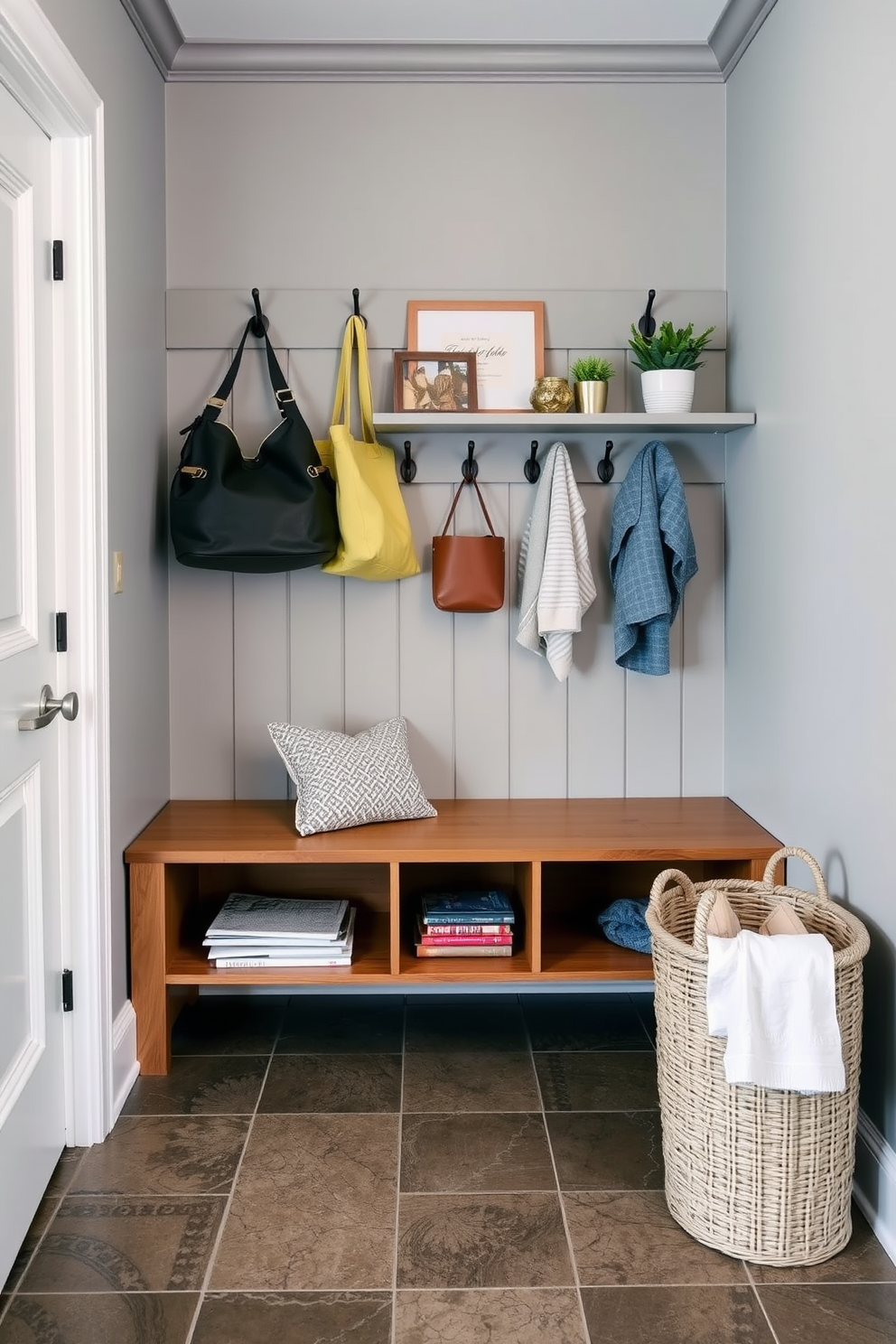 A functional drop zone designed for keys and mail features a sleek wooden bench with built-in storage underneath. Above the bench, there are hooks for hanging bags and coats, and a small shelf for decorative items and plants. The walls are painted in a soft gray, creating a calming atmosphere, while the floor is covered in durable, patterned tile for easy maintenance. A stylish basket sits nearby to hold miscellaneous items, ensuring the space remains organized and inviting.