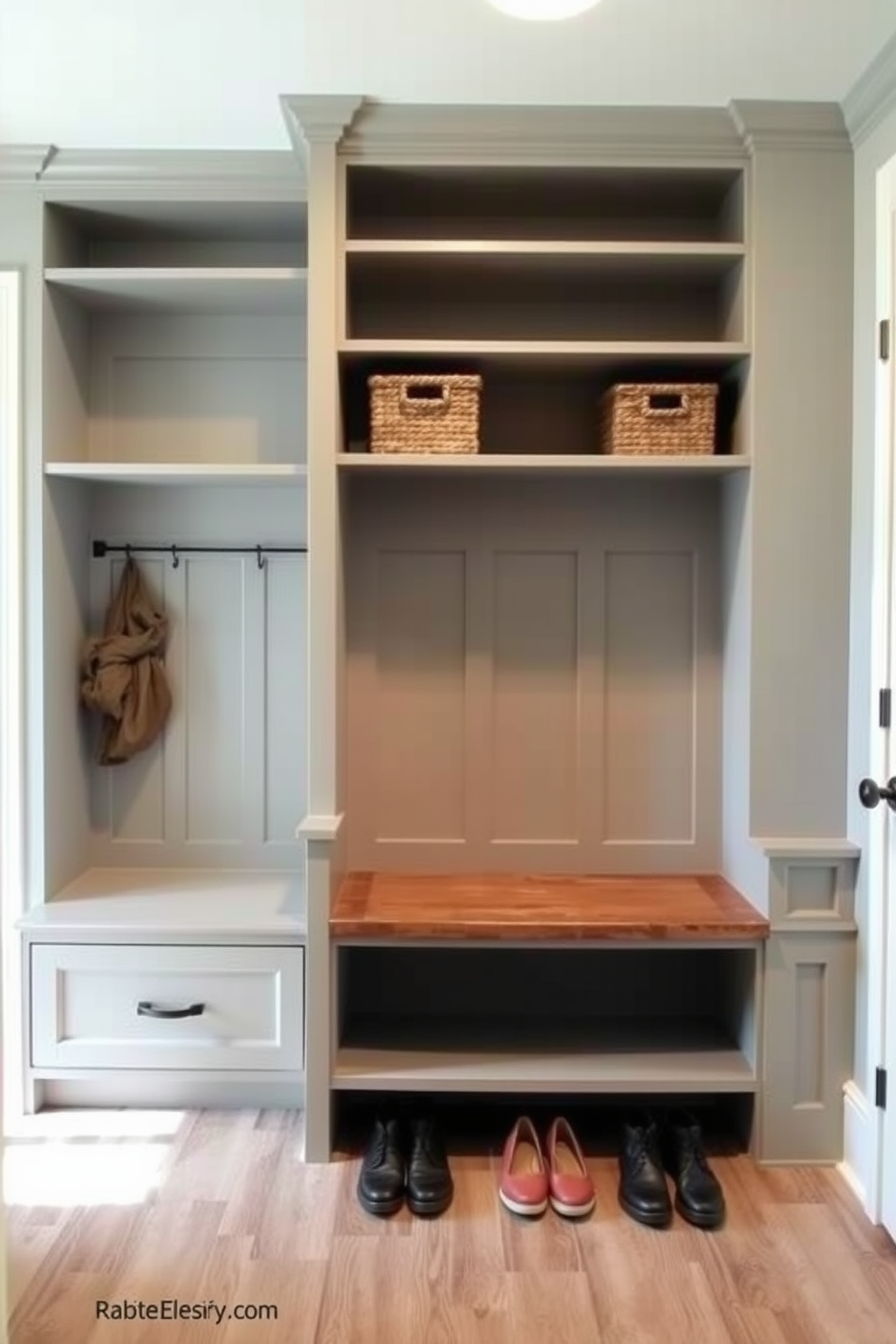 A functional mudroom featuring cubbies for organized storage solutions. The cubbies are built into the wall with a combination of open shelves and closed compartments, painted in a soft gray hue. A bench is positioned beneath the cubbies, providing a comfortable spot to sit while putting on shoes. The flooring is a durable tile that mimics the look of wood, adding warmth to the space.