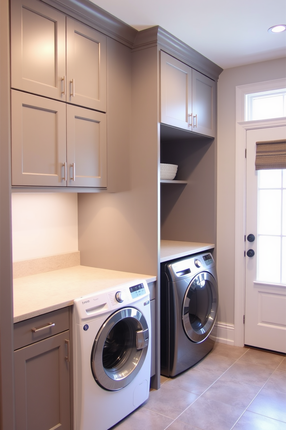 A functional mudroom laundry room features hidden laundry appliances seamlessly integrated behind stylish cabinet doors. The cabinetry is painted in a soft gray, creating a clean and organized look, while a durable tile floor adds practicality to the space.