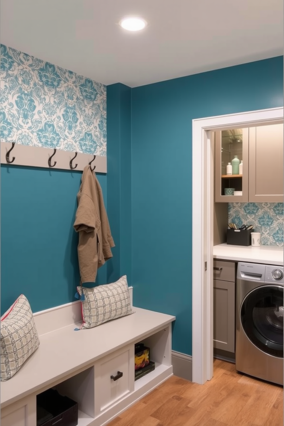 A cozy mudroom features an accent wall adorned with intricate patterned wallpaper that adds character to the space. The room is equipped with built-in benches and hooks for coats, creating a functional and stylish entryway. The laundry room showcases a modern design with sleek cabinetry and ample counter space for folding clothes. Bright lighting illuminates the space, while a decorative backsplash complements the overall aesthetic.