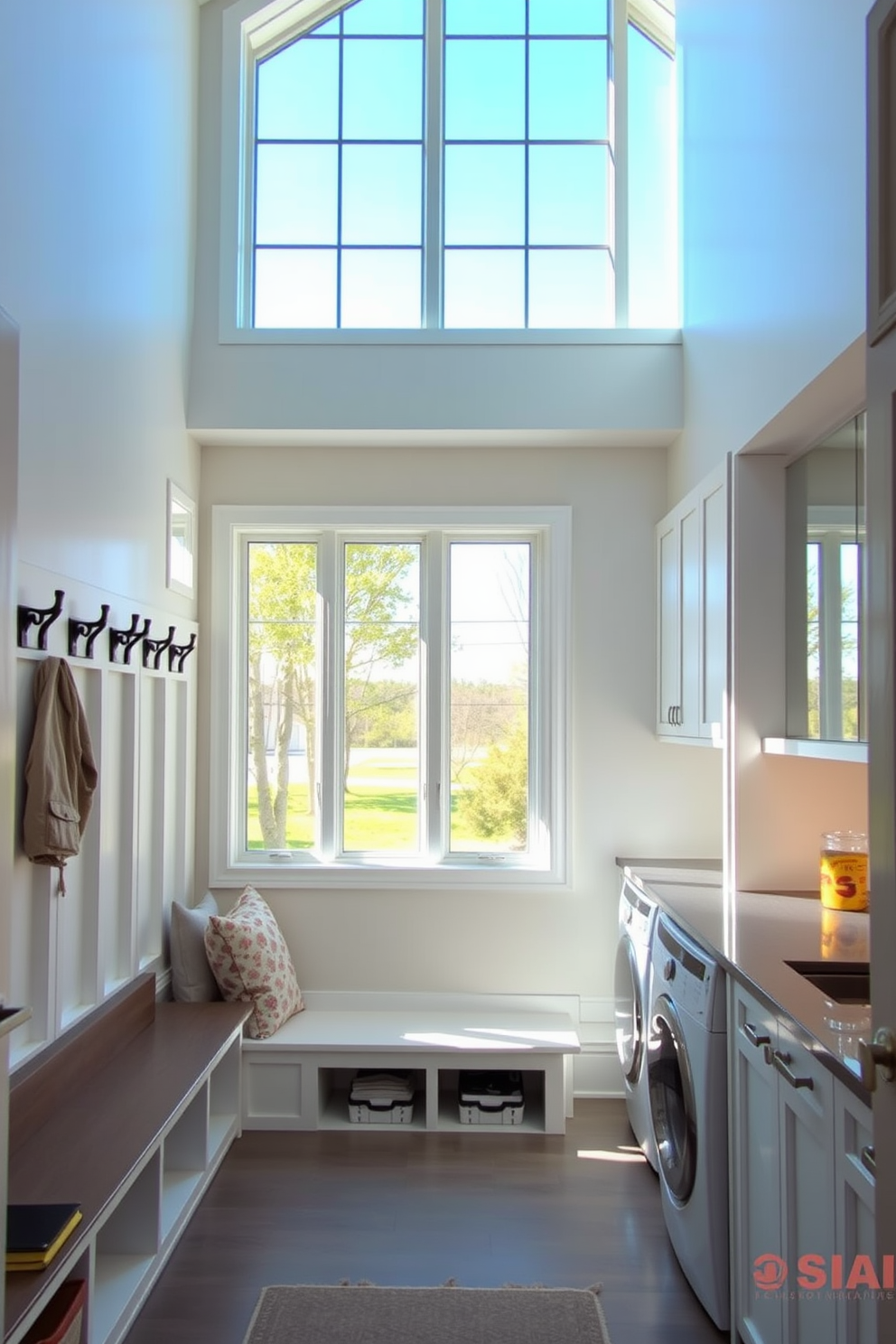 A bright and airy mudroom features large windows that invite abundant natural light. The space is designed with built-in storage benches and hooks, creating an organized and welcoming entryway. The laundry room is equipped with modern appliances and ample counter space for folding clothes. Large windows enhance the room's functionality while providing a view of the outdoors.