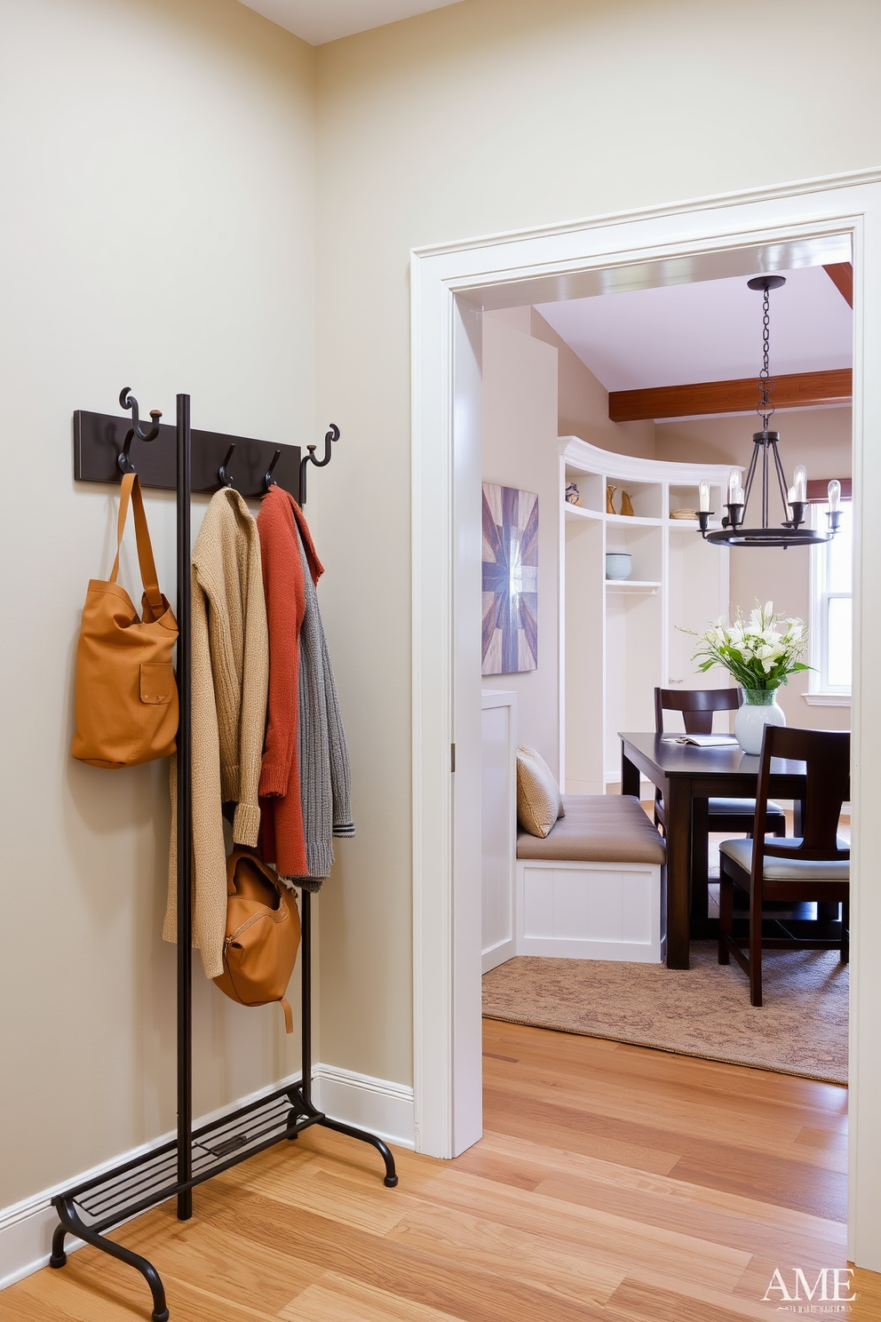 A stylish coat rack is positioned near the dining area, crafted from sleek metal with a modern design. It features multiple hooks for hanging coats and bags, complementing the overall aesthetic of the space. The mudroom near the dining room is designed with functionality in mind, showcasing built-in benches and storage cubbies. The color palette includes warm neutrals that enhance the inviting atmosphere of the home.