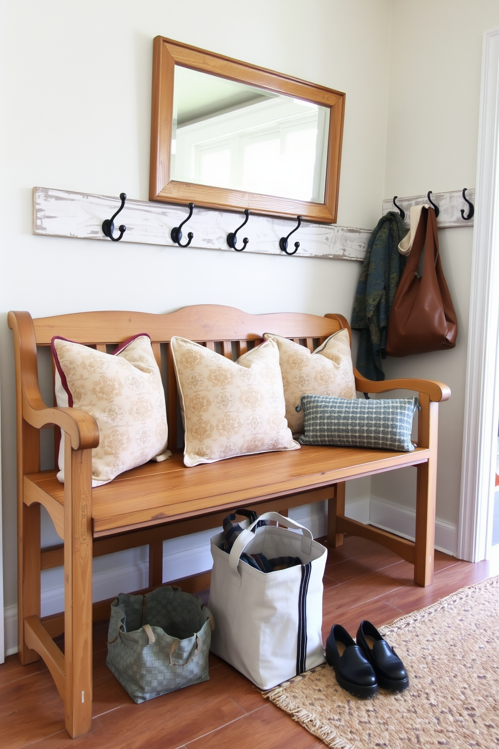 A vintage wooden bench with a distressed finish is placed against the wall, adding rustic charm to the mudroom. The bench is adorned with soft, patterned cushions and surrounded by hooks for hanging coats and bags, creating a welcoming entryway near the dining room.