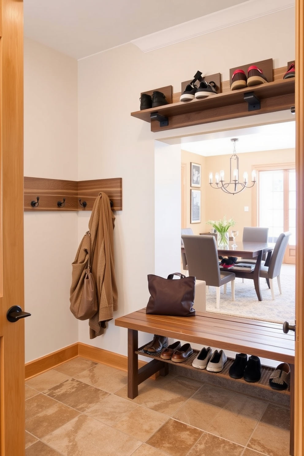 A functional and stylish mudroom features wall-mounted shoe racks that provide ample storage and organization for footwear. The space is designed with a warm color palette, incorporating natural wood elements and a durable tile floor that complements the adjacent dining room.