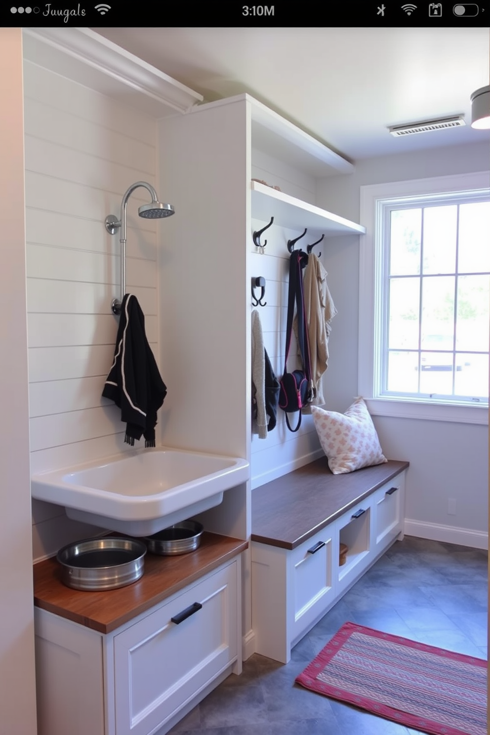 A functional pet station is designed with a washing area featuring a raised tub and handheld showerhead for easy bathing. The space includes built-in storage for pet supplies and a designated area for food and water bowls. The mudroom is designed for practicality and organization, featuring a bench with storage underneath and hooks for coats and leashes. Natural light floods the space through a window, enhancing the inviting atmosphere near the garage entrance.