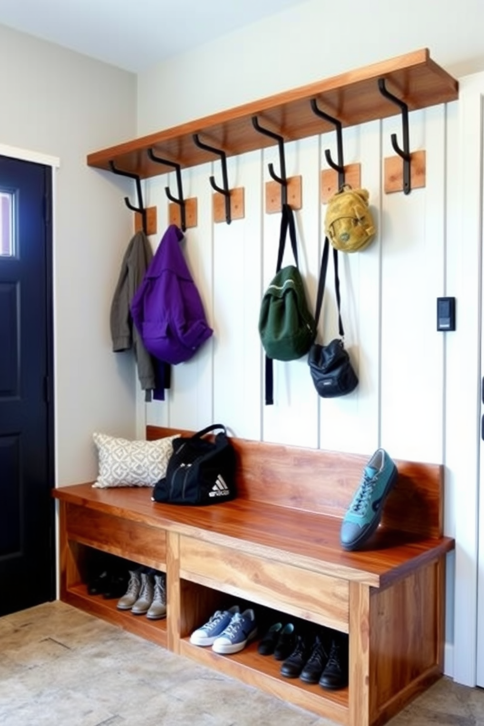 A functional mudroom near the garage features built-in wooden benches with ample storage underneath for shoes. Hooks line the wall for backpacks and jackets, offering easy access and organization for busy families.