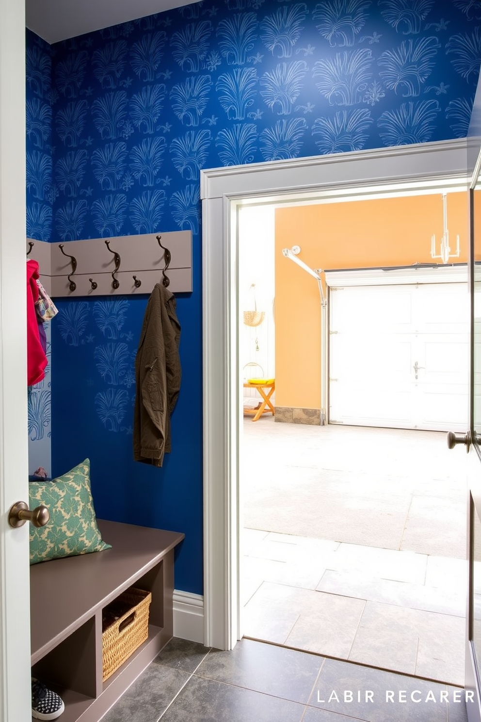 A mudroom adjacent to the garage featuring an accent wall adorned with bold wallpaper. The space includes built-in storage benches with hooks above for coats and bags, and a durable tile floor for easy cleaning.