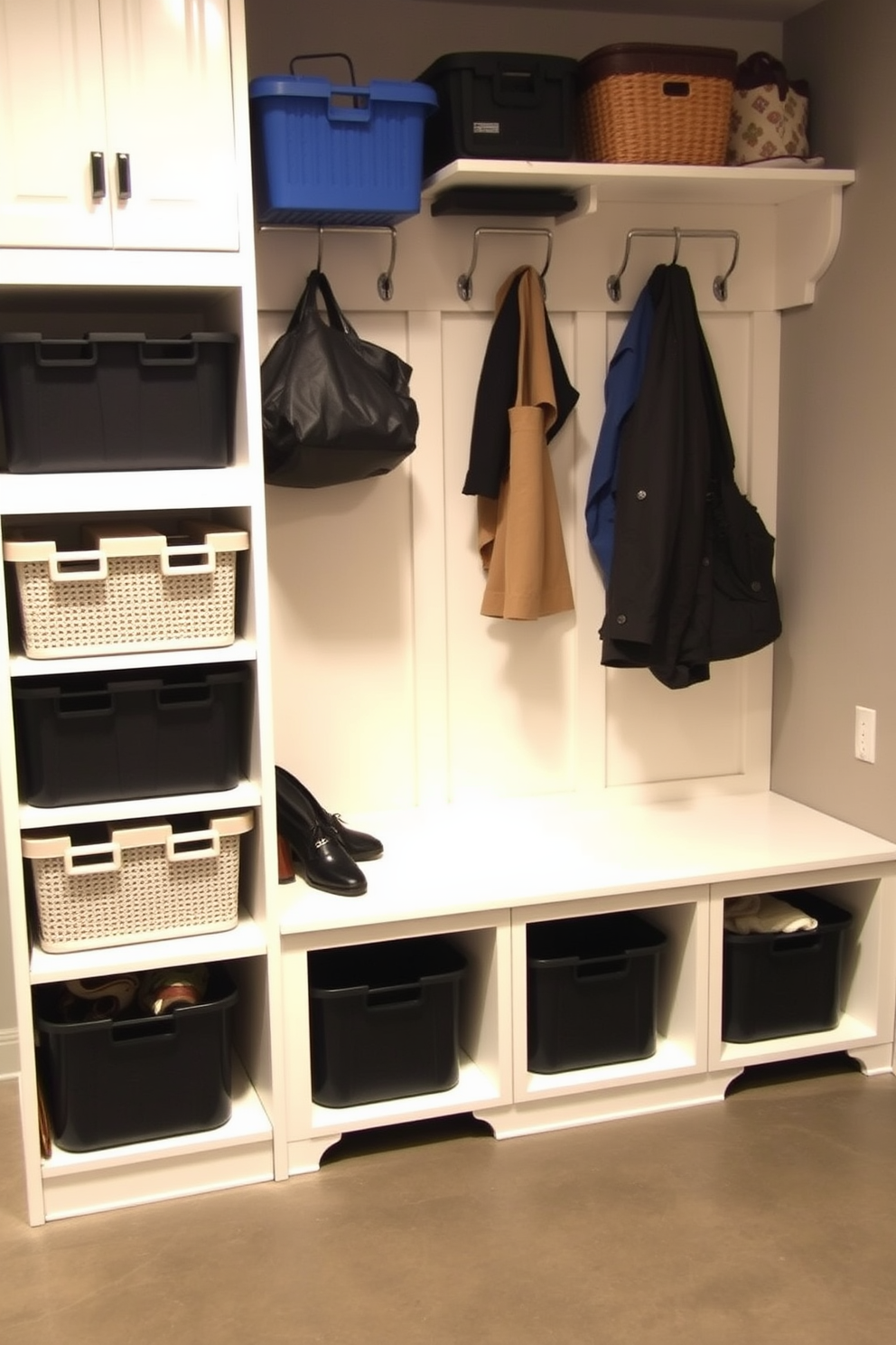 A functional mudroom near the garage features labeled bins for organized storage, ensuring easy access to everyday items. The space includes a built-in bench with hooks above for coats and bags, complemented by a durable floor that can withstand heavy foot traffic.