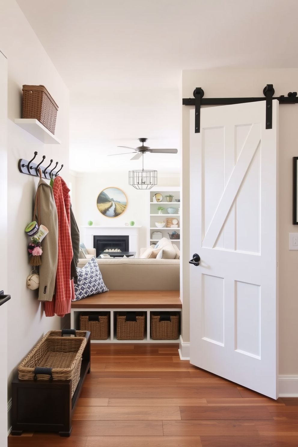 A mudroom featuring a sliding barn door that seamlessly connects to the living room. The space includes hooks for coats, a bench for seating, and storage baskets that enhance organization and style.