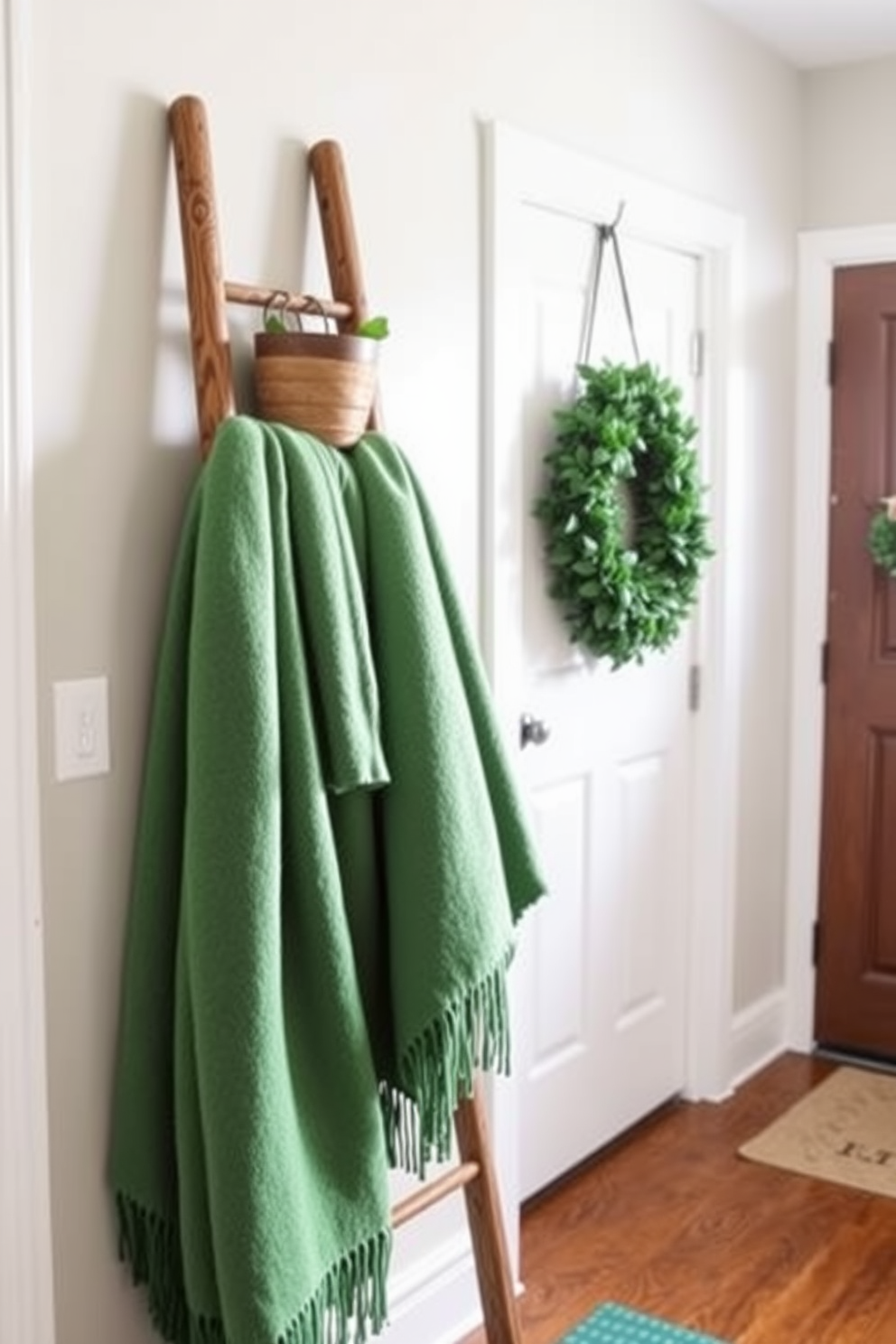 A decorative ladder leans against the wall in a cozy mudroom. It is adorned with soft green blankets, adding a touch of warmth and color for St. Patrick's Day decorating ideas.