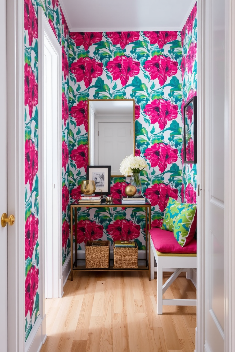 A narrow entryway featuring bold wallpaper that creates a striking focal point. The space includes a sleek console table adorned with decorative items and a stylish mirror above it. To the side, a compact bench with vibrant cushions provides seating while maximizing space. The flooring is a light hardwood that complements the vivid colors of the wallpaper, enhancing the overall design.