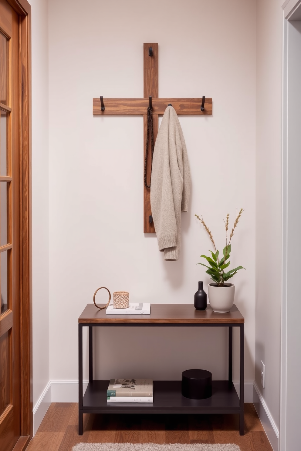 A stylish narrow entryway featuring a wall-mounted coat rack made of natural wood. The space is enhanced by a sleek console table below the rack, adorned with decorative items and a small potted plant.