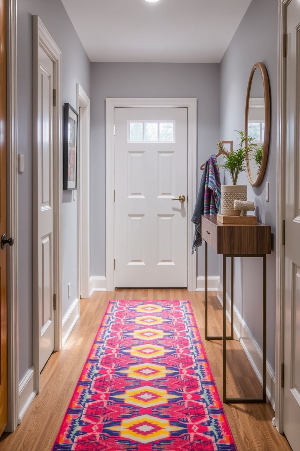 A colorful runner rug adds warmth and vibrancy to a narrow entryway. The rug features a bold geometric pattern that complements the surrounding decor and enhances the overall aesthetic. Incorporate sleek storage solutions such as a slim console table against one wall. Add a few decorative elements like a small potted plant and a stylish mirror to create an inviting atmosphere.