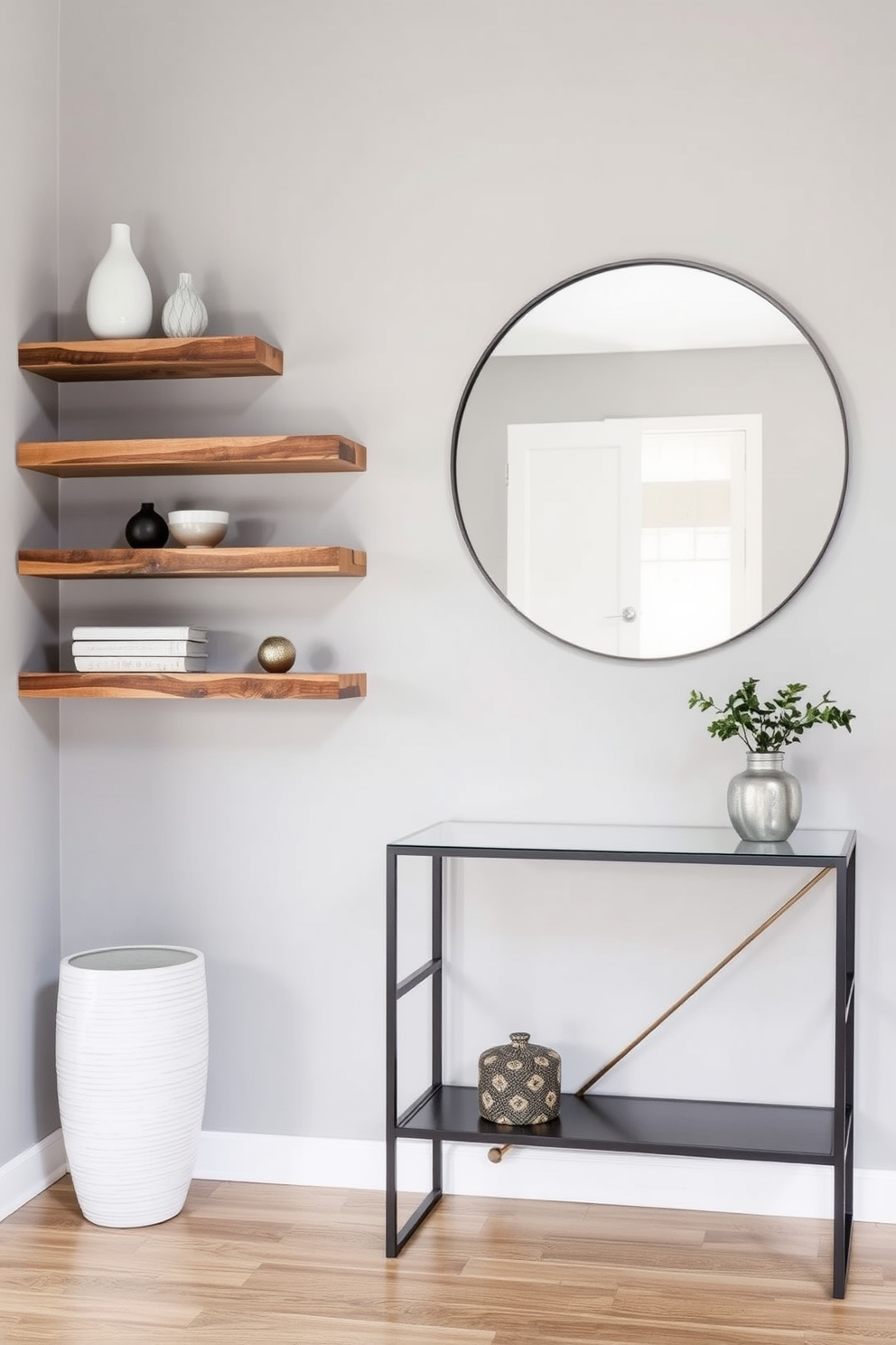 Floating shelves for decorative accents. The shelves are made of reclaimed wood and are arranged asymmetrically on a soft gray wall. Narrow entryway design ideas. A sleek console table with a minimalist design sits against the wall, complemented by a large round mirror above it.