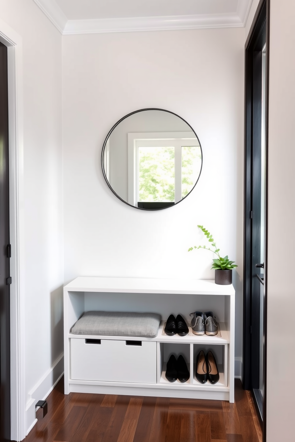 A narrow foyer features a sleek console table with built-in storage beneath. A round mirror hangs above the table, reflecting light and creating an illusion of space. Incorporate a stylish bench with hidden compartments for shoes and bags. The walls are painted in a light color to enhance brightness, and a small potted plant adds a touch of greenery.