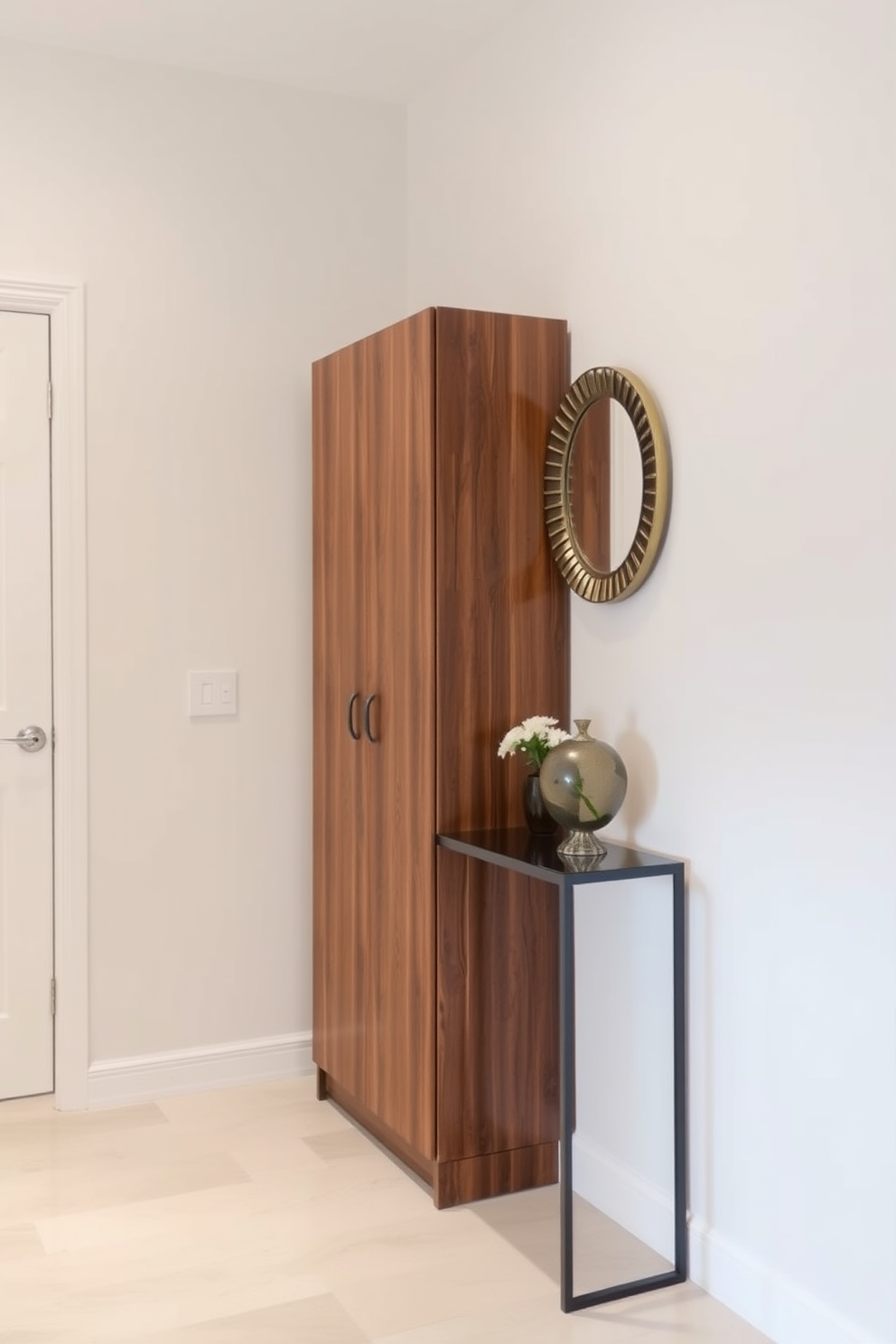 A tall narrow cabinet stands against the wall, providing ample storage while maintaining a sleek profile. The cabinet features a rich wood finish that complements the light neutral tones of the foyer. The foyer is designed with a minimalist approach, featuring a narrow console table adorned with a decorative mirror above it. Soft lighting highlights the space, creating an inviting atmosphere as guests enter the home.