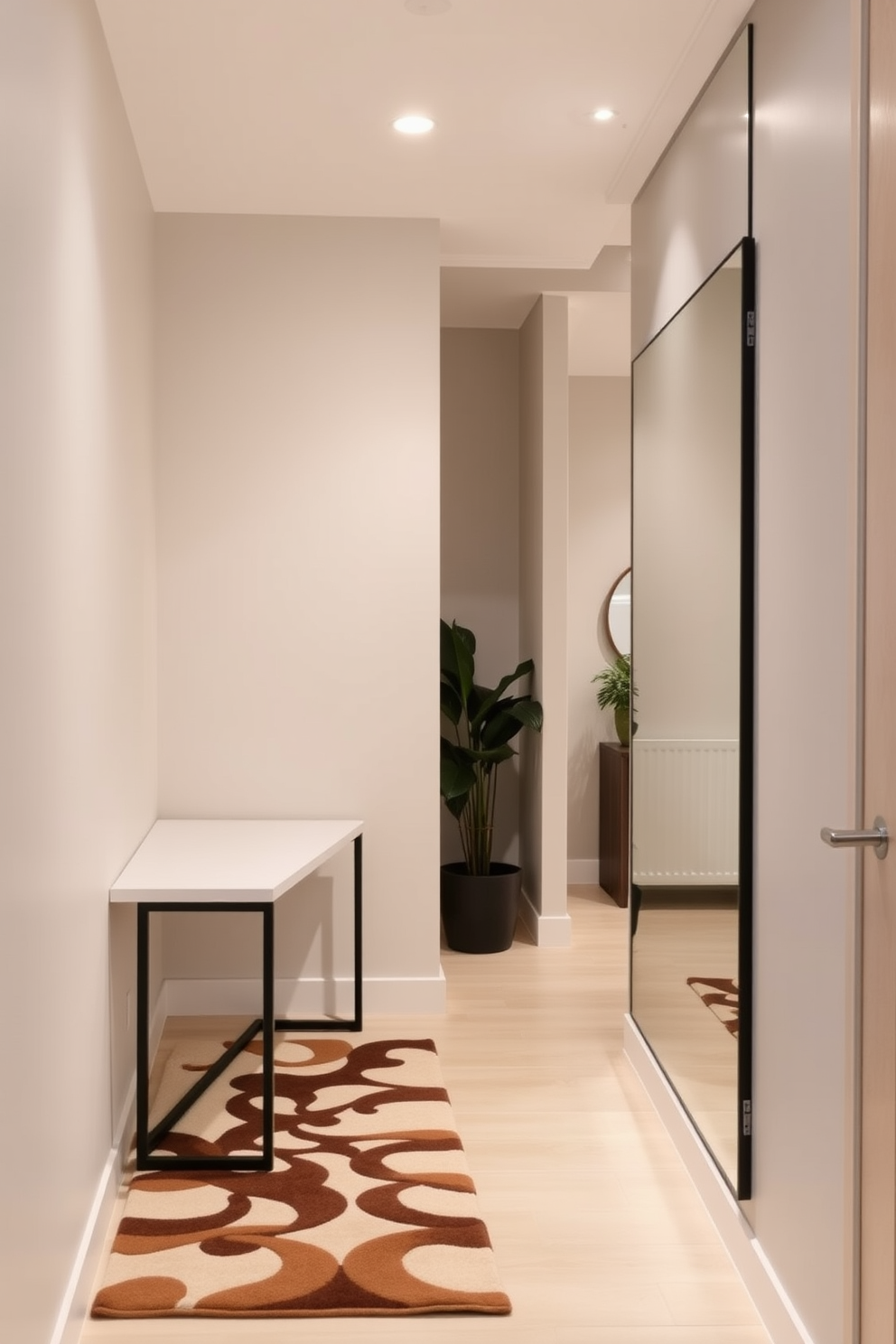 A narrow foyer with a sleek console table against the wall. The space features a unique door mat that complements the overall style, inviting guests into the home. On the opposite wall, a large mirror reflects light, enhancing the sense of space. Soft lighting fixtures above create a warm atmosphere, while a small potted plant adds a touch of greenery.