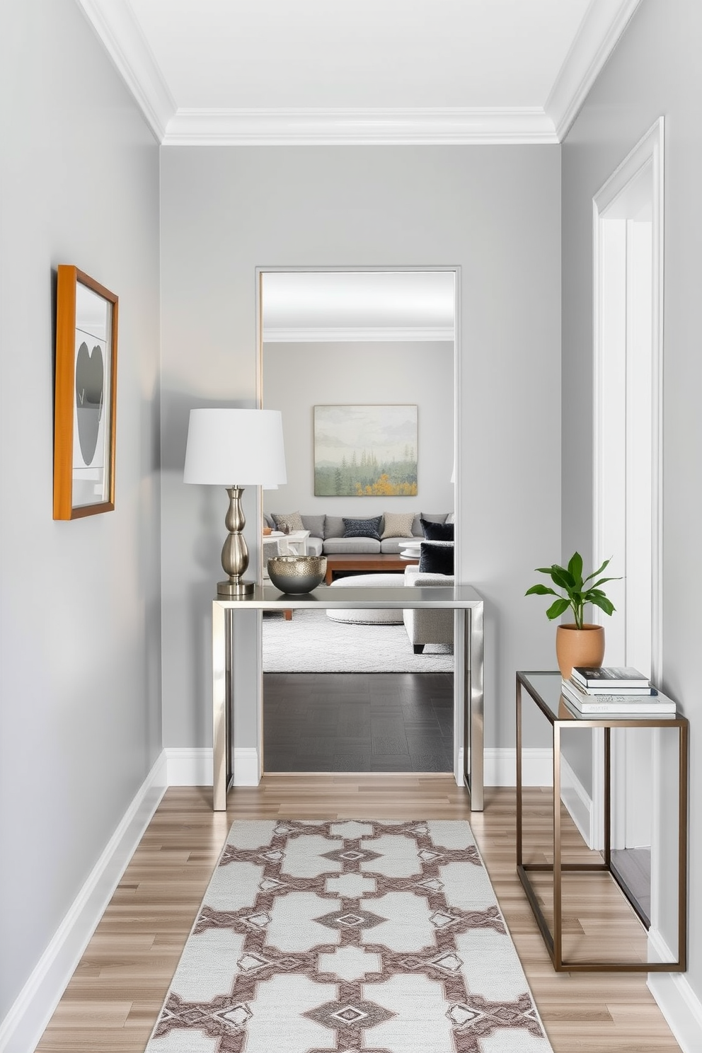 A narrow foyer featuring a sleek console table against the wall, adorned with a stylish lamp and a decorative bowl. The walls are painted in a soft gray hue, complemented by a runner rug with geometric patterns that leads into the main living area. To the right of the console table, there is a small side table showcasing a potted plant and a stack of art books. Above the console, a framed mirror adds depth and brightness to the space, enhancing the welcoming atmosphere of the foyer.