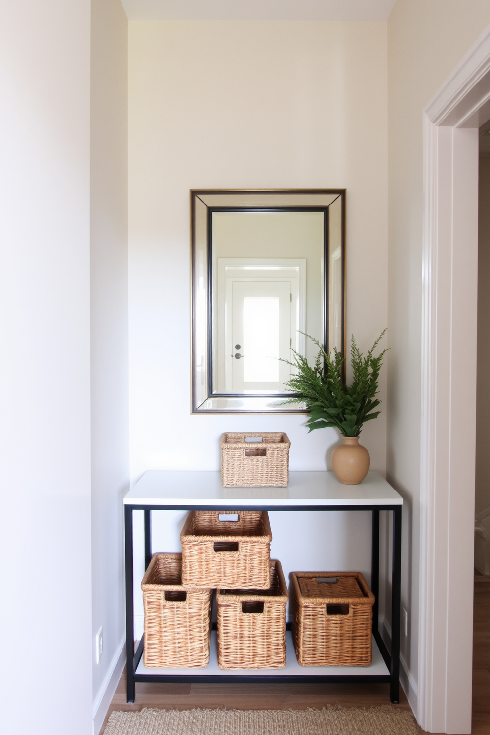 A narrow foyer designed for functionality and style. Decorative baskets are placed on a sleek console table, providing organization while adding texture to the space. The walls are painted in a soft neutral tone to create an inviting atmosphere. A statement mirror hangs above the table, reflecting light and making the area feel more spacious.