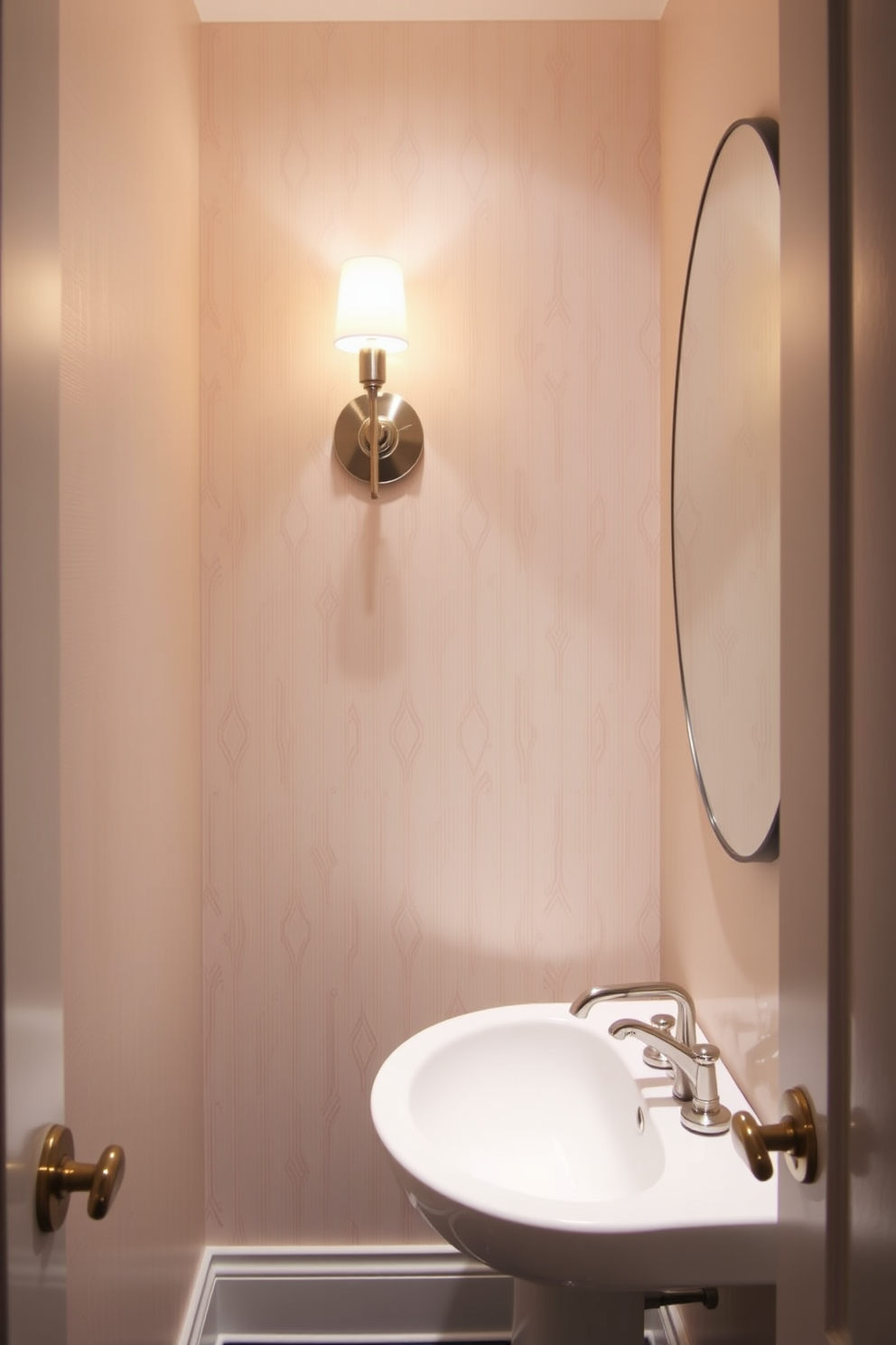 A narrow powder room features stylish sconces that provide elegant lighting. The walls are adorned with a soft, neutral wallpaper, and the floor is laid with sleek, dark tiles.