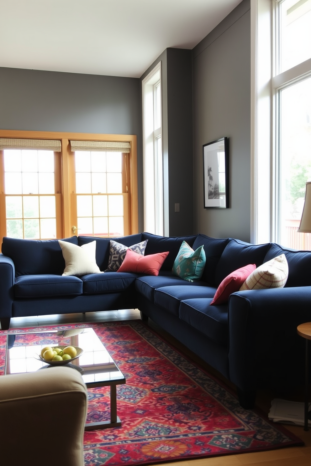 A cozy living room featuring a navy blue sofa that invites relaxation. The floor is adorned with a colorful patterned rug that adds vibrancy to the space. Large windows allow natural light to flood in, highlighting the rich textures of the sofa. Complementary throw pillows in various colors are scattered across the couch for added comfort.