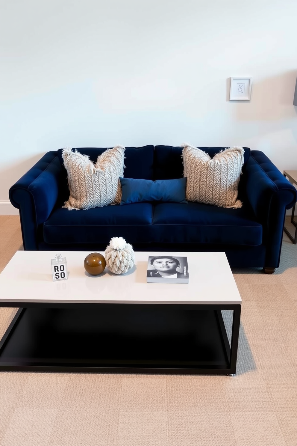 A navy couch is positioned against a crisp white backdrop, creating a striking contrast that enhances the room's elegance. Complementing the couch, a sleek coffee table sits in front, adorned with a few carefully selected decor pieces. The surrounding walls are painted in a soft neutral shade, allowing the navy couch to be the focal point of the living space. Plush throw pillows in varying textures and patterns are arranged on the couch, adding depth and inviting comfort to the design.