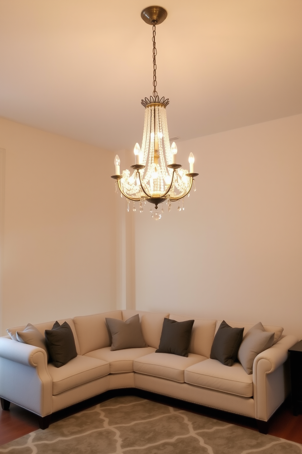 An elegant chandelier hangs gracefully from the ceiling, adorned with crystal accents that reflect light beautifully. The warm glow it emits adds a touch of glam to the space, creating an inviting atmosphere. The living room features a neutral color palette, with soft beige walls and a plush cream sofa. Accents of gray and taupe are introduced through decorative pillows and a stylish area rug, creating a serene and sophisticated environment.