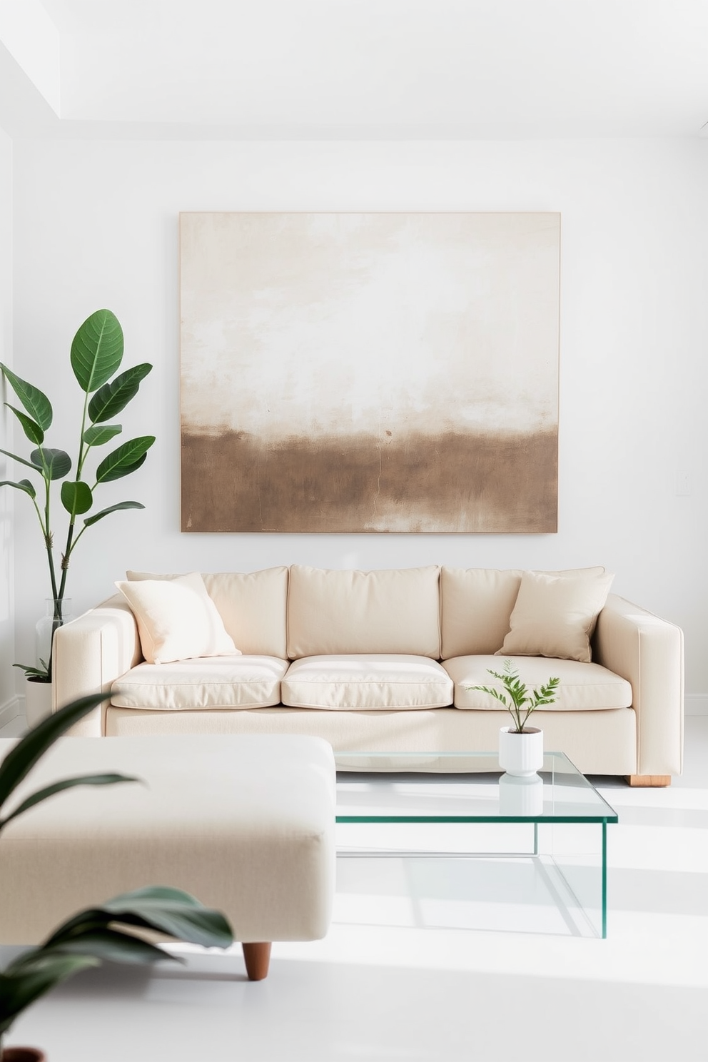 A minimalist living room features a soft beige sofa with clean lines and a low profile. A simple glass coffee table sits in front, complemented by a single potted plant in the corner. The walls are painted in a crisp white, enhancing the airy feel of the space. A large abstract painting with muted tones hangs above the sofa, adding a touch of elegance without overwhelming the simplicity of the design.