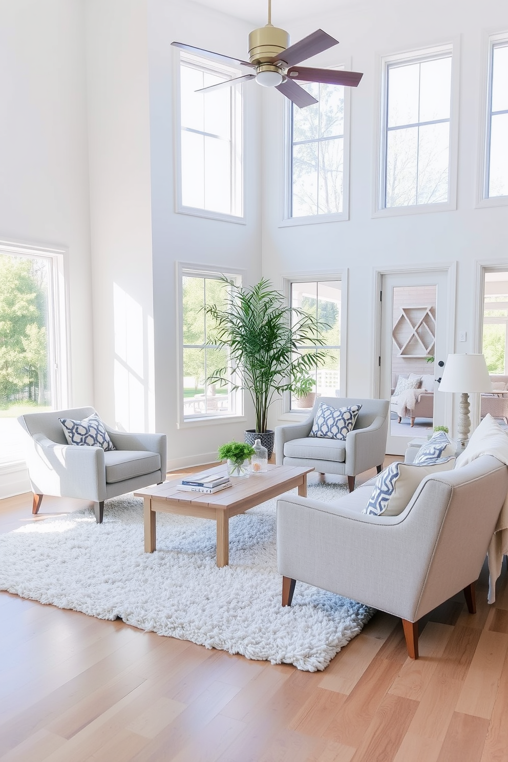 A cozy living room featuring accent chairs in soft gray and beige. The chairs are paired with a light wooden coffee table and a plush area rug that complements the color scheme. The walls are painted in a warm white, creating an inviting atmosphere. Large windows allow natural light to flood the space, enhancing the overall brightness of the room.