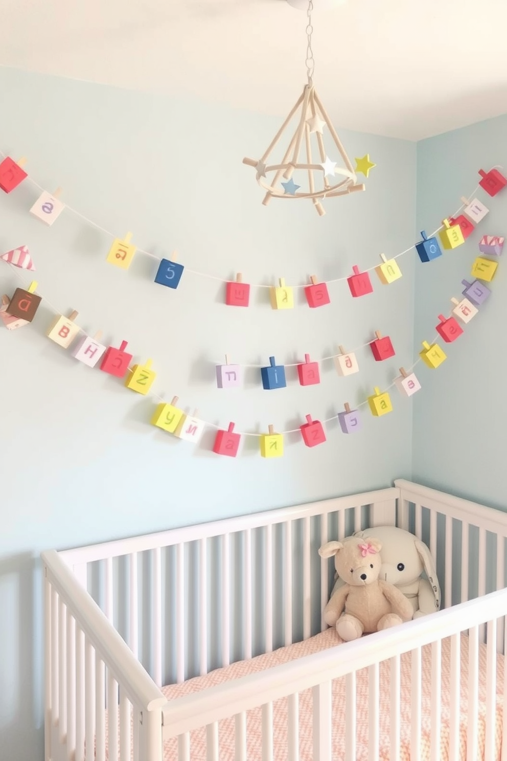 A whimsical nursery adorned with DIY paper dreidel garland decorations. The garland features colorful paper dreidels strung together, creating a festive atmosphere perfect for Hanukkah celebrations. Soft pastel colors dominate the nursery, with light blue walls and a cozy white crib. Plush toys and a starry mobile hang above, adding to the playful and warm environment.