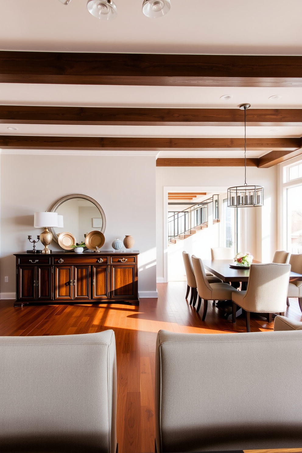 A spacious open floor plan dining room features a stunning buffet table made of dark wood positioned against a light-colored wall. The buffet is adorned with decorative plates and a stylish lamp, providing both functionality and elegance to the space. Surrounding the dining area are a set of plush upholstered chairs paired with a large rectangular dining table. Natural light floods the room through expansive windows, highlighting the warm tones of the hardwood floor and creating an inviting atmosphere.