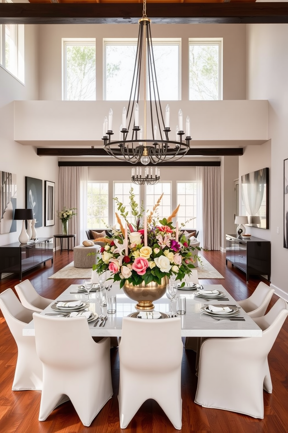 A modern open floor plan dining room featuring a statement dining table centerpiece. The centerpiece consists of an artistic floral arrangement in a bold vase, surrounded by elegant tableware and candles. The dining area is bathed in natural light from large windows, with a stylish chandelier hanging above the table. The walls are painted in a soft neutral tone, complemented by warm wooden flooring and contemporary art pieces adorning the walls.